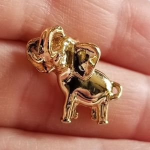 Tiny vintage elephant pin by Gerry's lapel gold tone trunk up